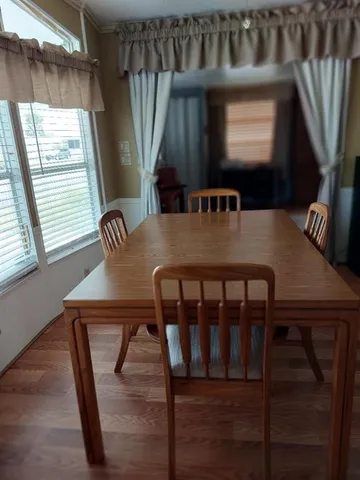 a view of a dining room with furniture and window