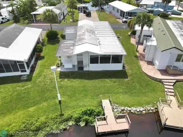 an aerial view of a house with swimming pool garden and outdoor seating
