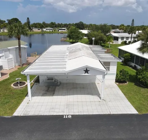 an aerial view of a house with a yard and lake view