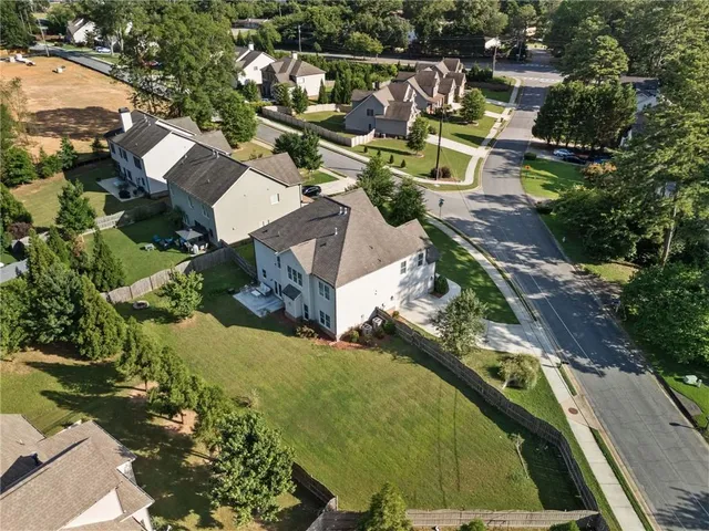 an aerial view of residential houses with outdoor space