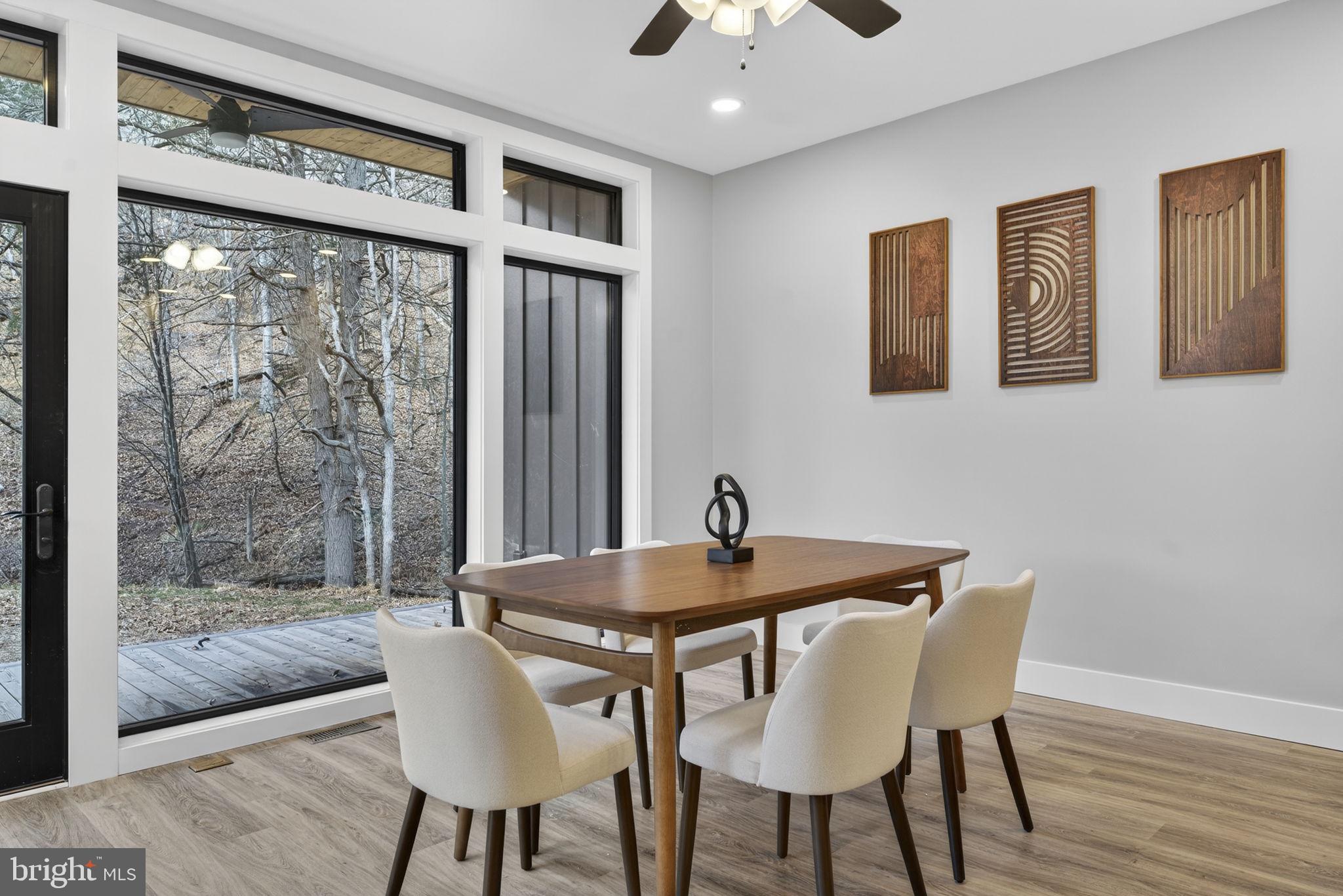 1956 Dove Hollow Road Mathias, WV 26812 - Photo 22 of 113 a view of a dining room with furniture wooden floor and chandelier