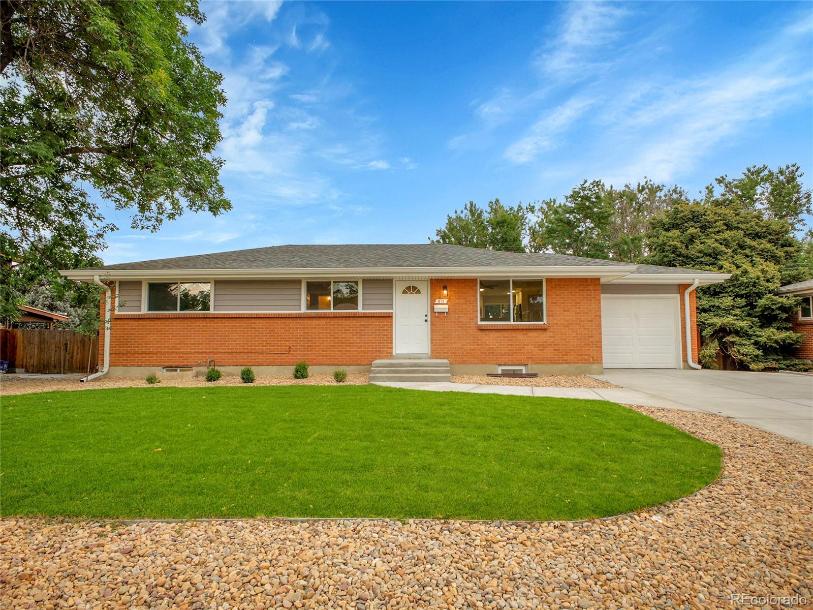 215 East Panama Drive Centennial, CO 80121 - Photo 1 of 50 a front view of a house with a garden