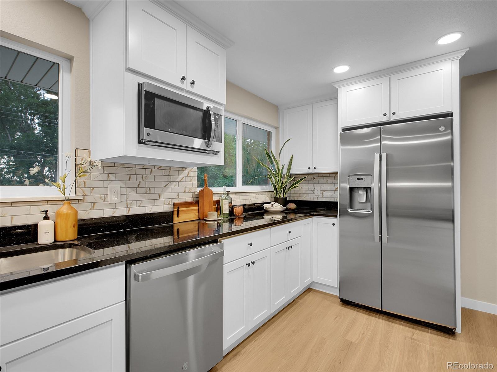 215 East Panama Drive Centennial, CO 80121 - Photo 12 of 50 a kitchen with stainless steel appliances a refrigerator sink and microwave