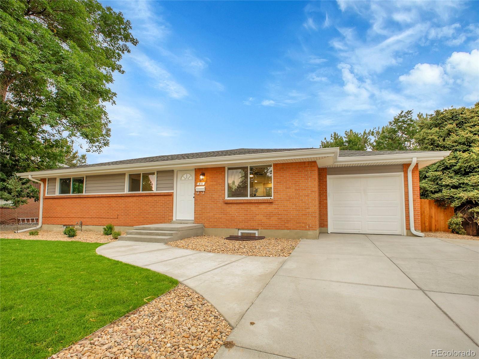 215 East Panama Drive Centennial, CO 80121 - Photo 2 of 50 a front view of house with yard and trees in the background