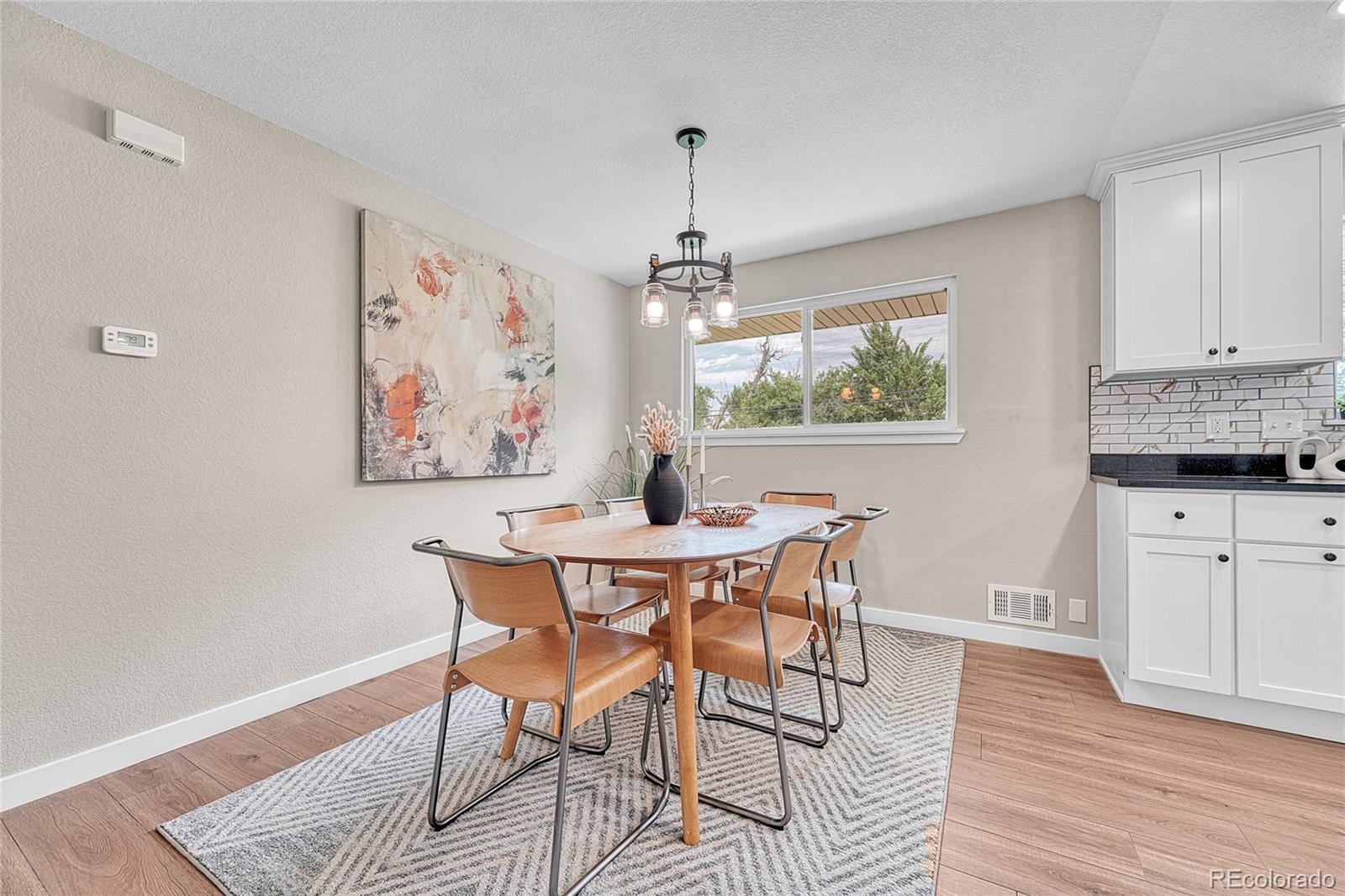 215 East Panama Drive Centennial, CO 80121 - Photo 27 of 50 a view of a dining room with furniture window and wooden floor