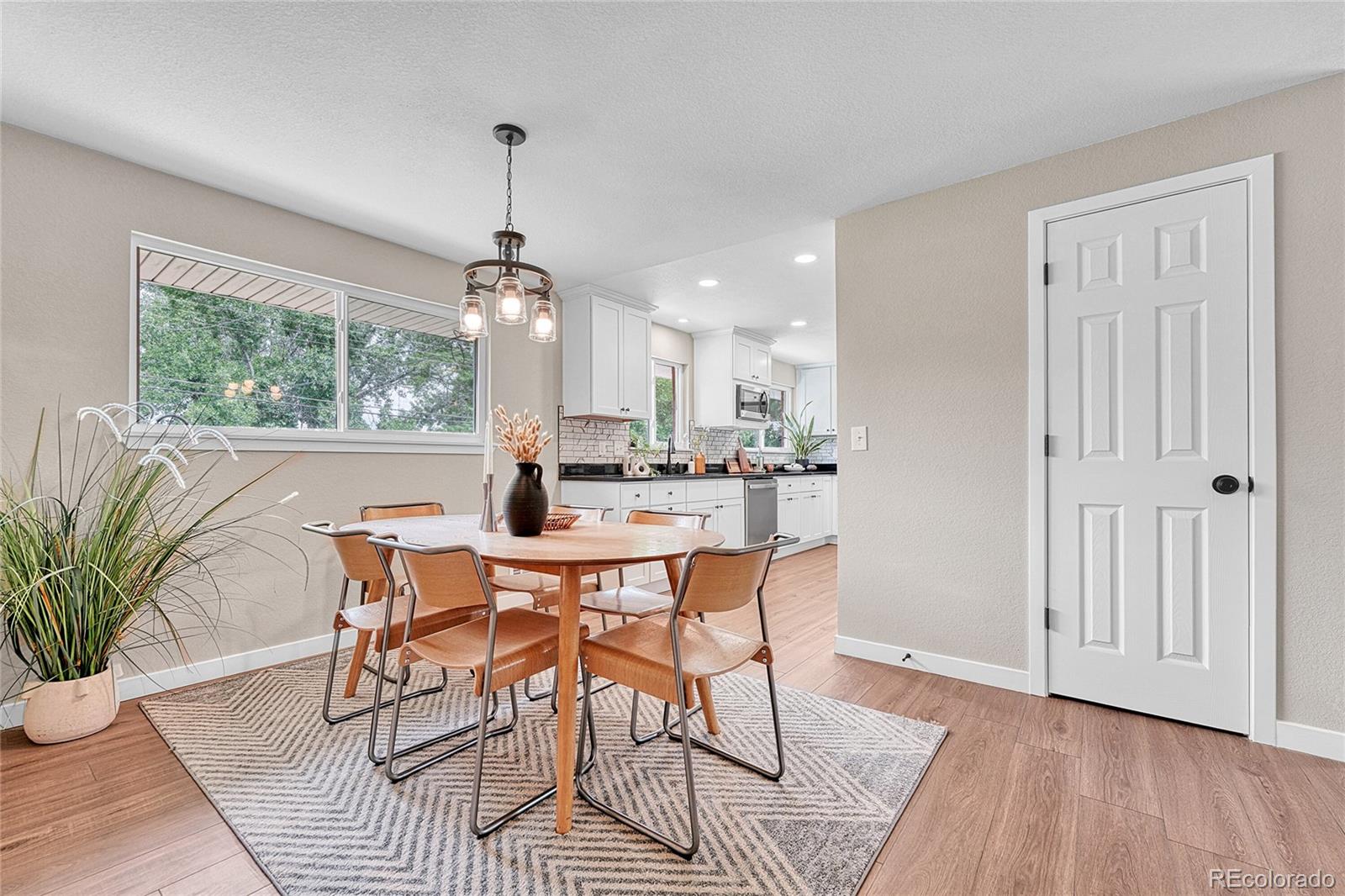 215 East Panama Drive Centennial, CO 80121 - Photo 28 of 50 a dining room with furniture window entryway and wooden floor