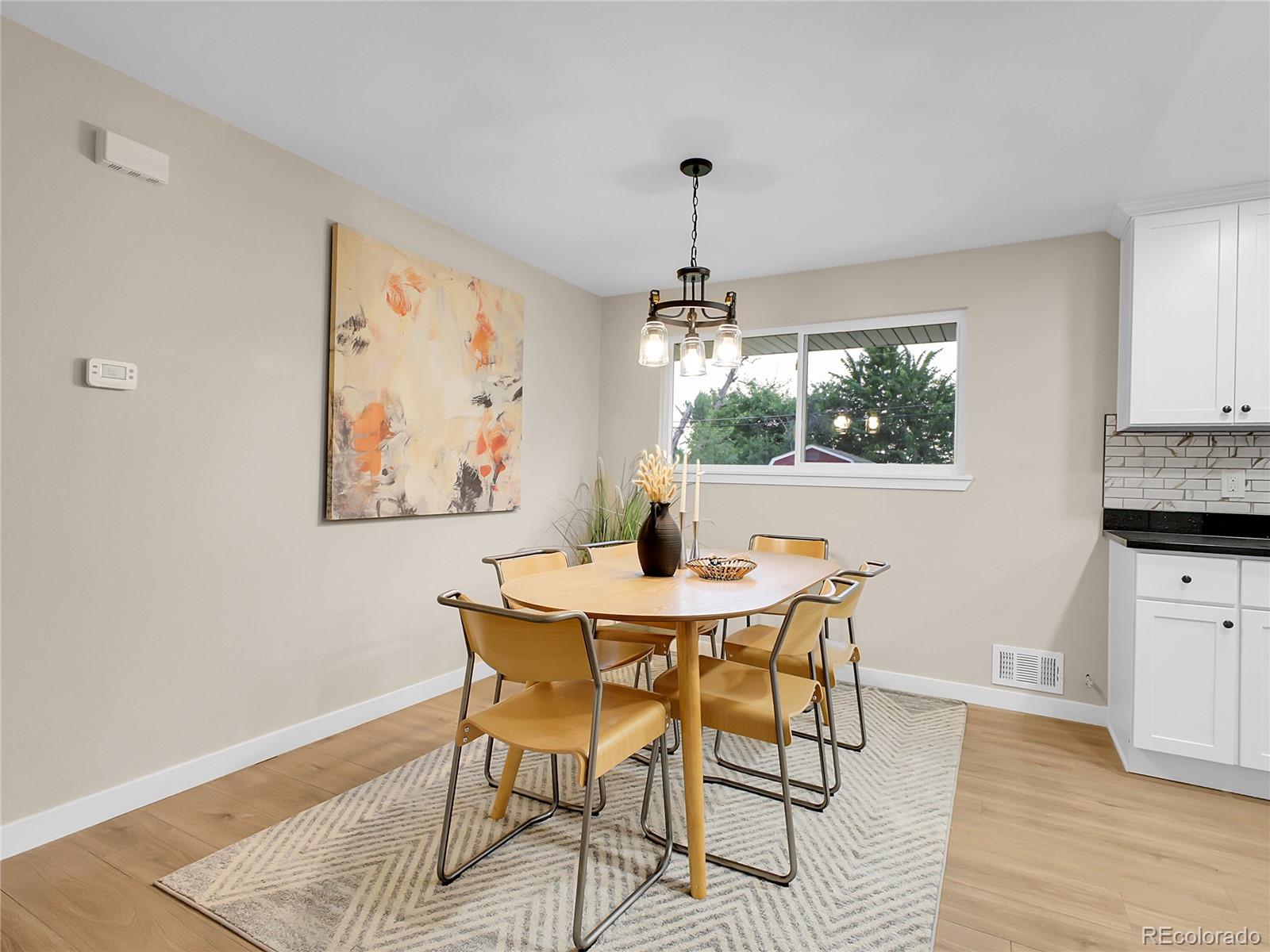 215 East Panama Drive Centennial, CO 80121 - Photo 3 of 50 a view of a dining room with furniture window and wooden floor