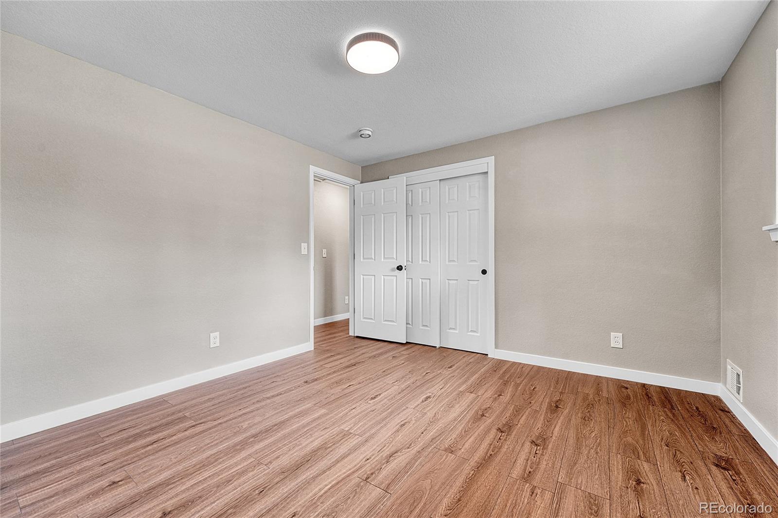 215 East Panama Drive Centennial, CO 80121 - Photo 31 of 50 a view of an empty room with wooden floor