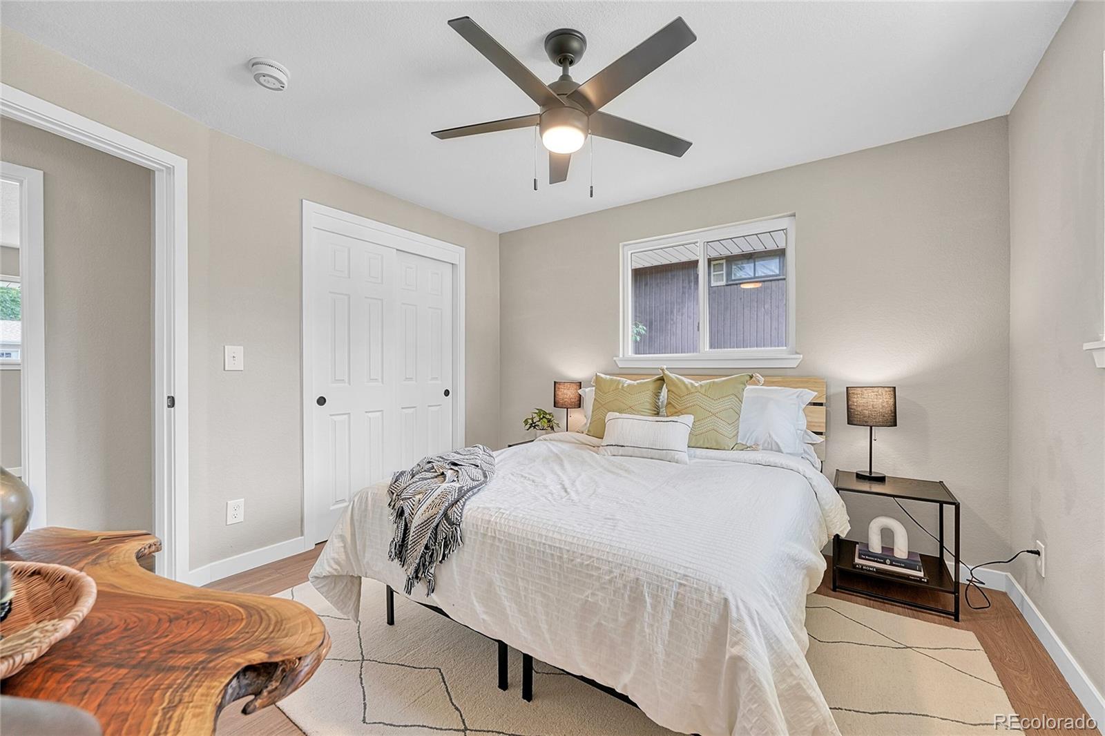 215 East Panama Drive Centennial, CO 80121 - Photo 33 of 50 a bedroom with a bed and a chandelier