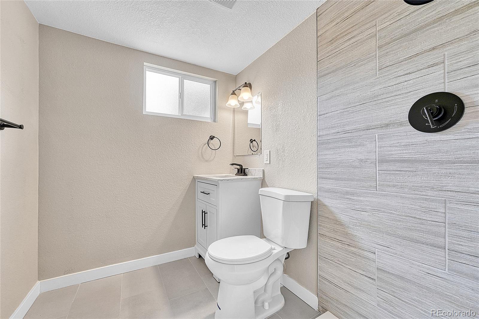 215 East Panama Drive Centennial, CO 80121 - Photo 40 of 50 a bathroom with a granite countertop toilet and a sink
