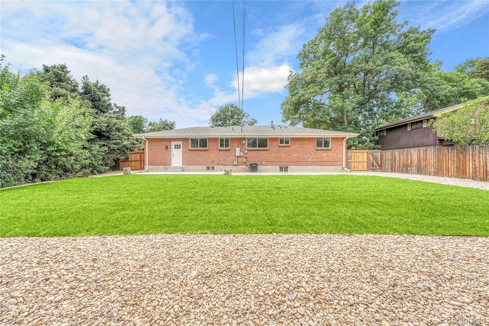 215 East Panama Drive Centennial, CO 80121 - Photo 42 of 50 a front view of a house with a yard and potted plants