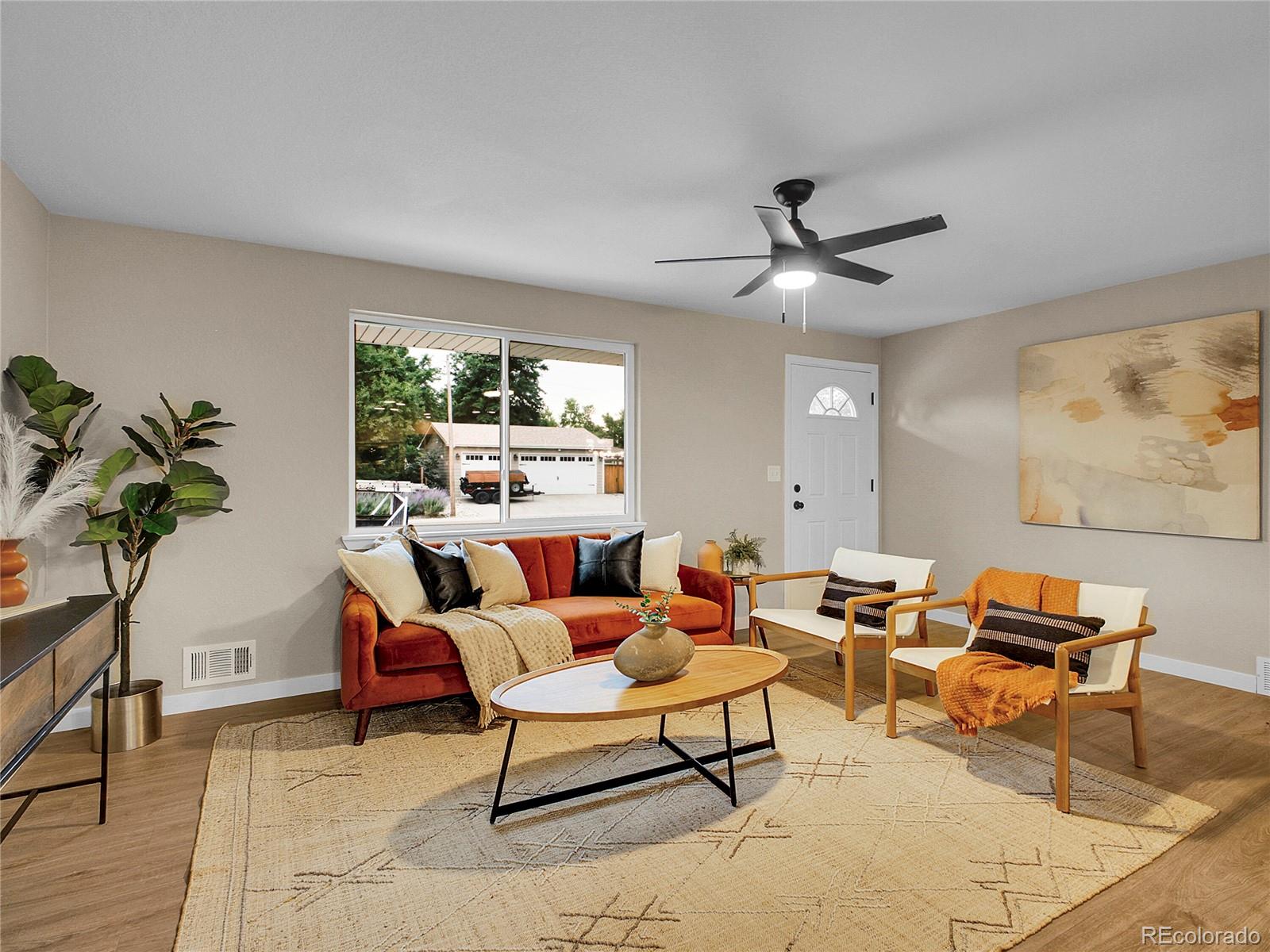 215 East Panama Drive Centennial, CO 80121 - Photo 8 of 50 a living room with furniture a window and a flat screen tv