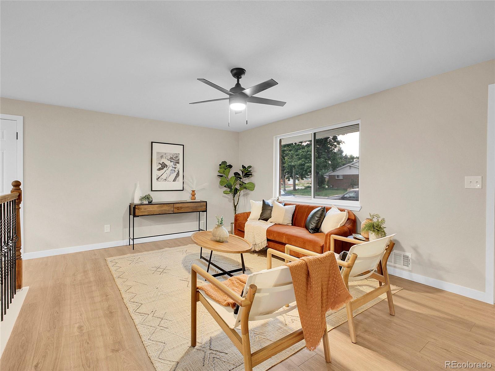 215 East Panama Drive Centennial, CO 80121 - Photo 9 of 50 a living room with furniture and a chandelier