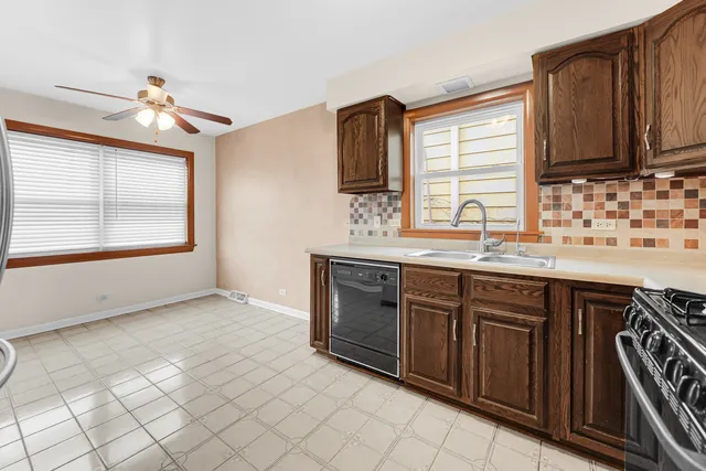 a kitchen with a sink stove and cabinets