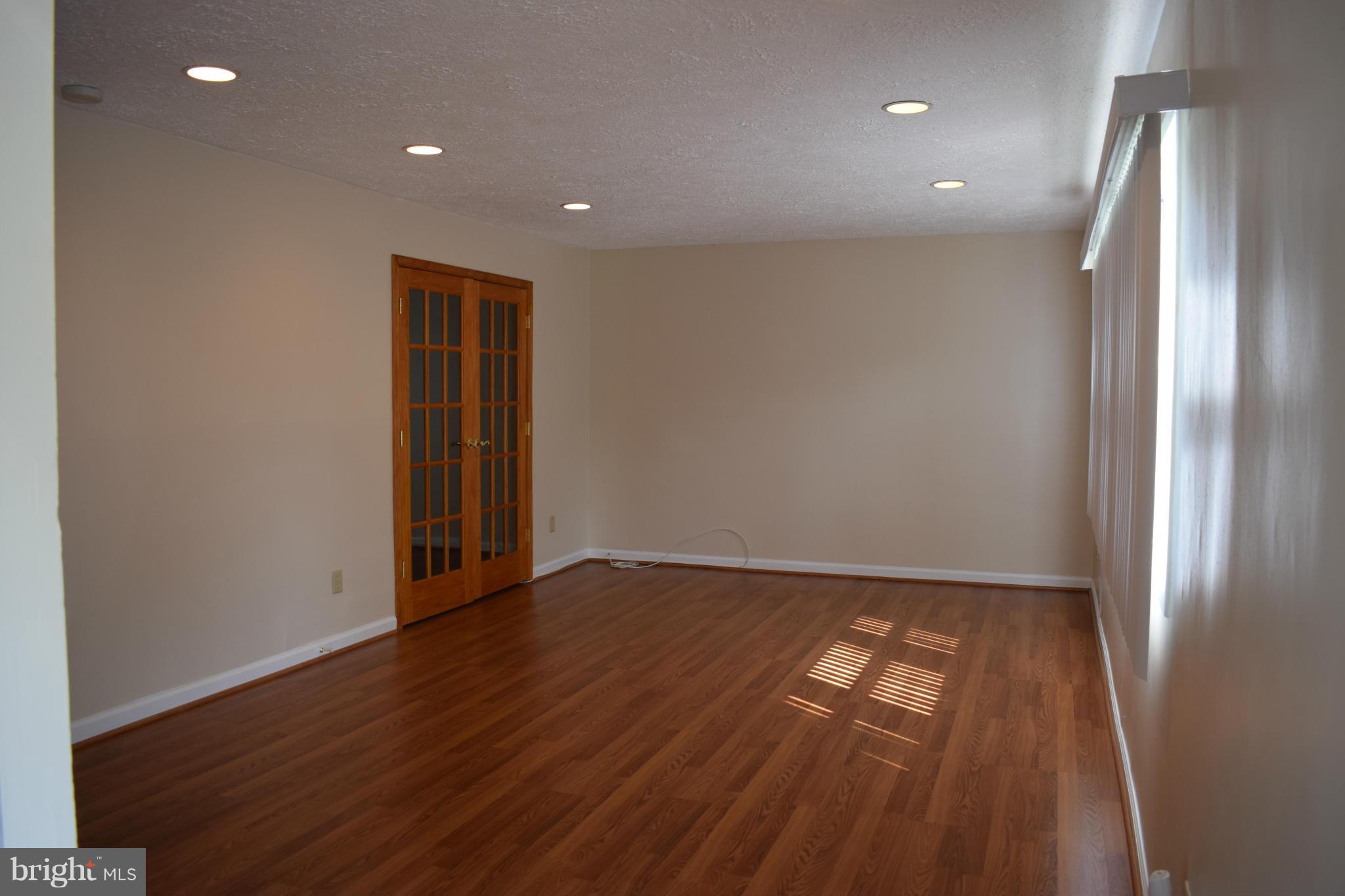 1902 Brookdale Road Windsor Mill, MD 21244 - Photo 2 of 13 an empty room with wooden floor and door