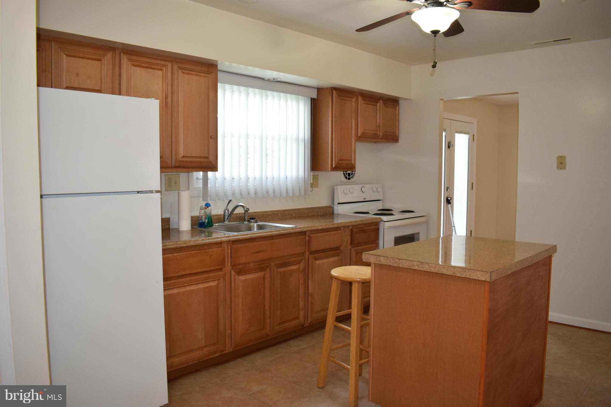 1902 Brookdale Road Windsor Mill, MD 21244 - Photo 12 of 13 a kitchen with cabinets a sink stainless steel appliances and a window