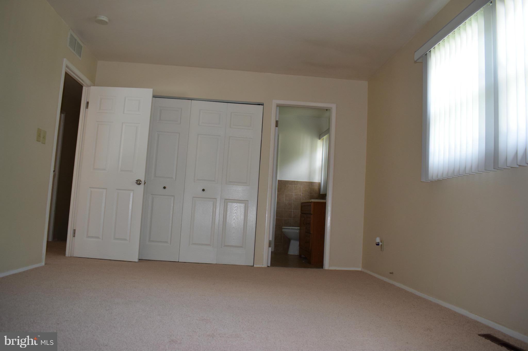 1902 Brookdale Road Windsor Mill, MD 21244 - Photo 8 of 13 an empty room with closet and a window