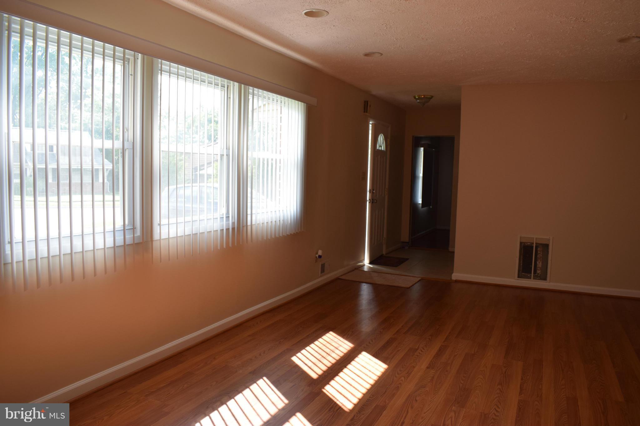 1902 Brookdale Road Windsor Mill, MD 21244 - Photo 9 of 13 a view of an empty room with wooden floor and a window