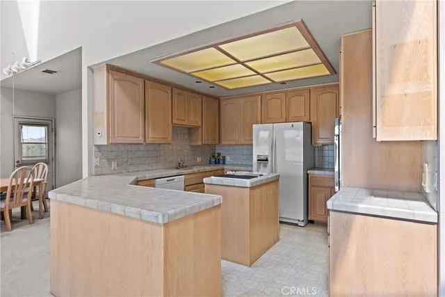 a kitchen with a stove and a refrigerator