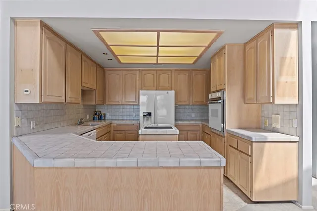 a kitchen with stainless steel appliances granite countertop a sink stove and cabinets