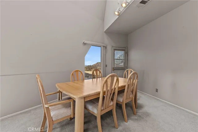 a living room with furniture a flat screen tv and a window