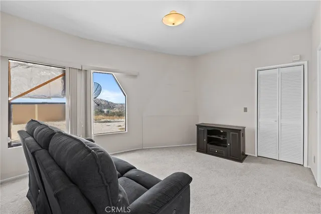 a bed room with a bed and a large window