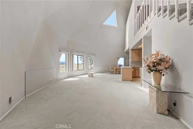 a living room with furniture a chandelier and a painting on the wall