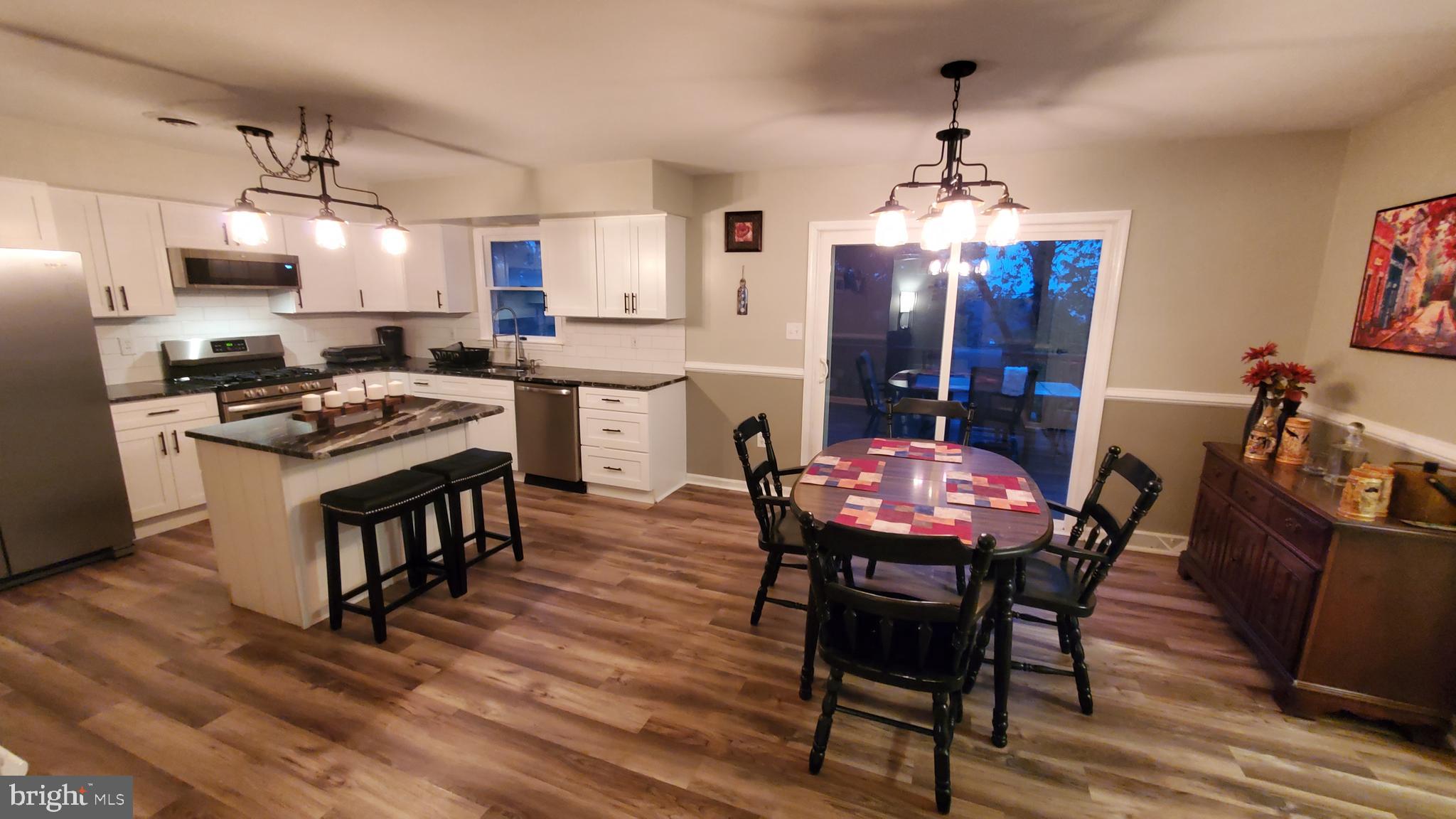 916 Timber Lane Reading, PA 19608 - Photo 13 of 29 a dining room with furniture a chandelier and wooden floor