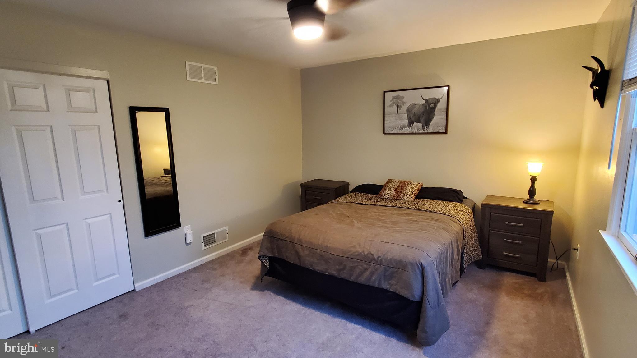 916 Timber Lane Reading, PA 19608 - Photo 28 of 29 a bedroom with a bed and a chandelier