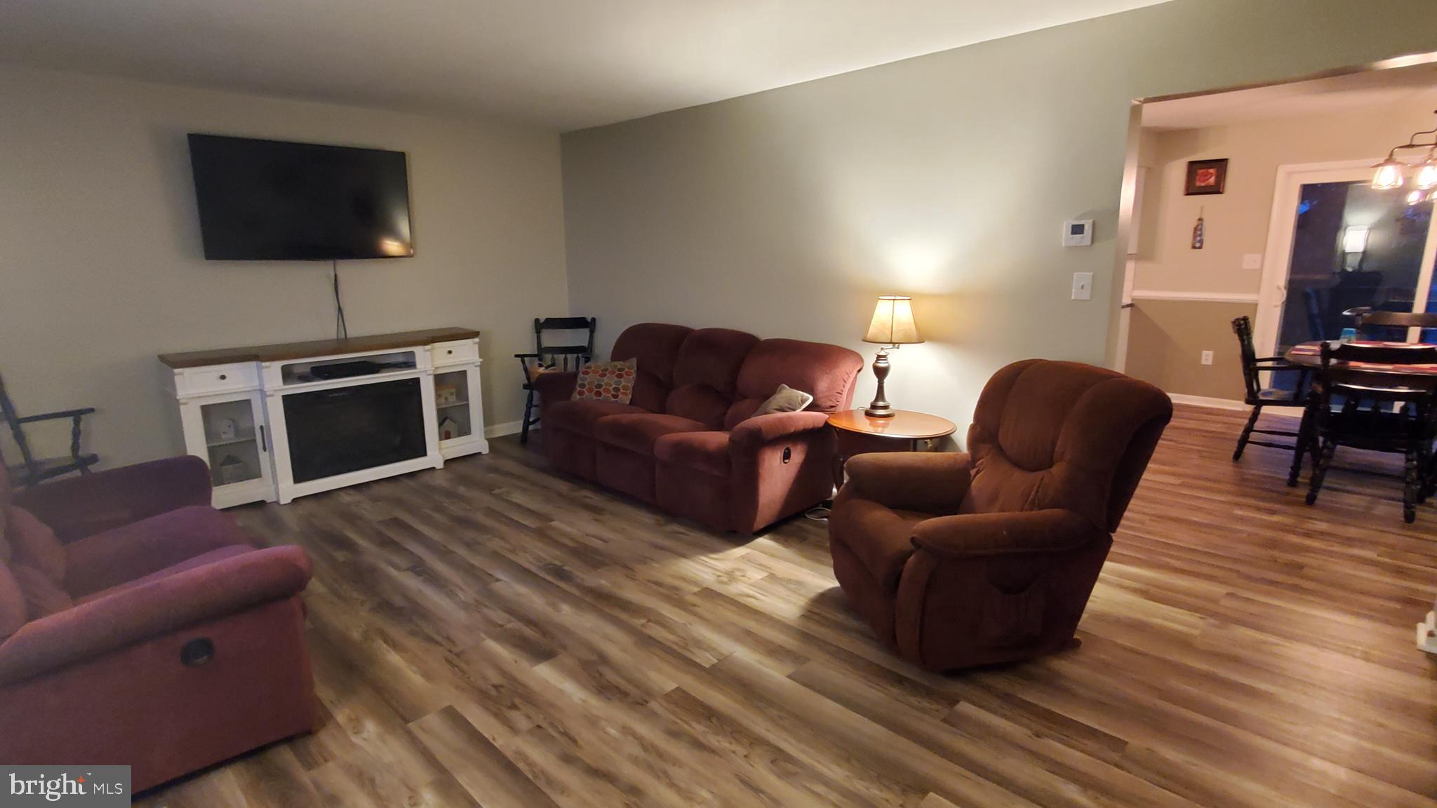 916 Timber Lane Reading, PA 19608 - Photo 5 of 29 a living room with furniture a flat screen tv and a fireplace