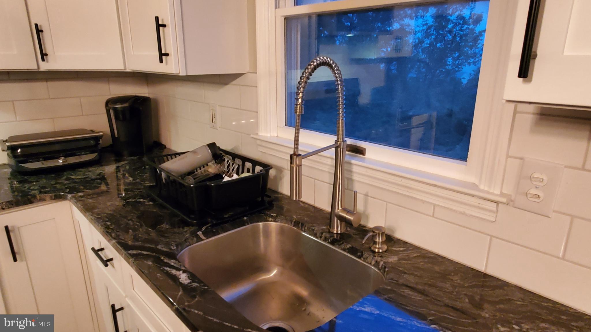 916 Timber Lane Reading, PA 19608 - Photo 7 of 29 a kitchen with a sink and a stove top oven