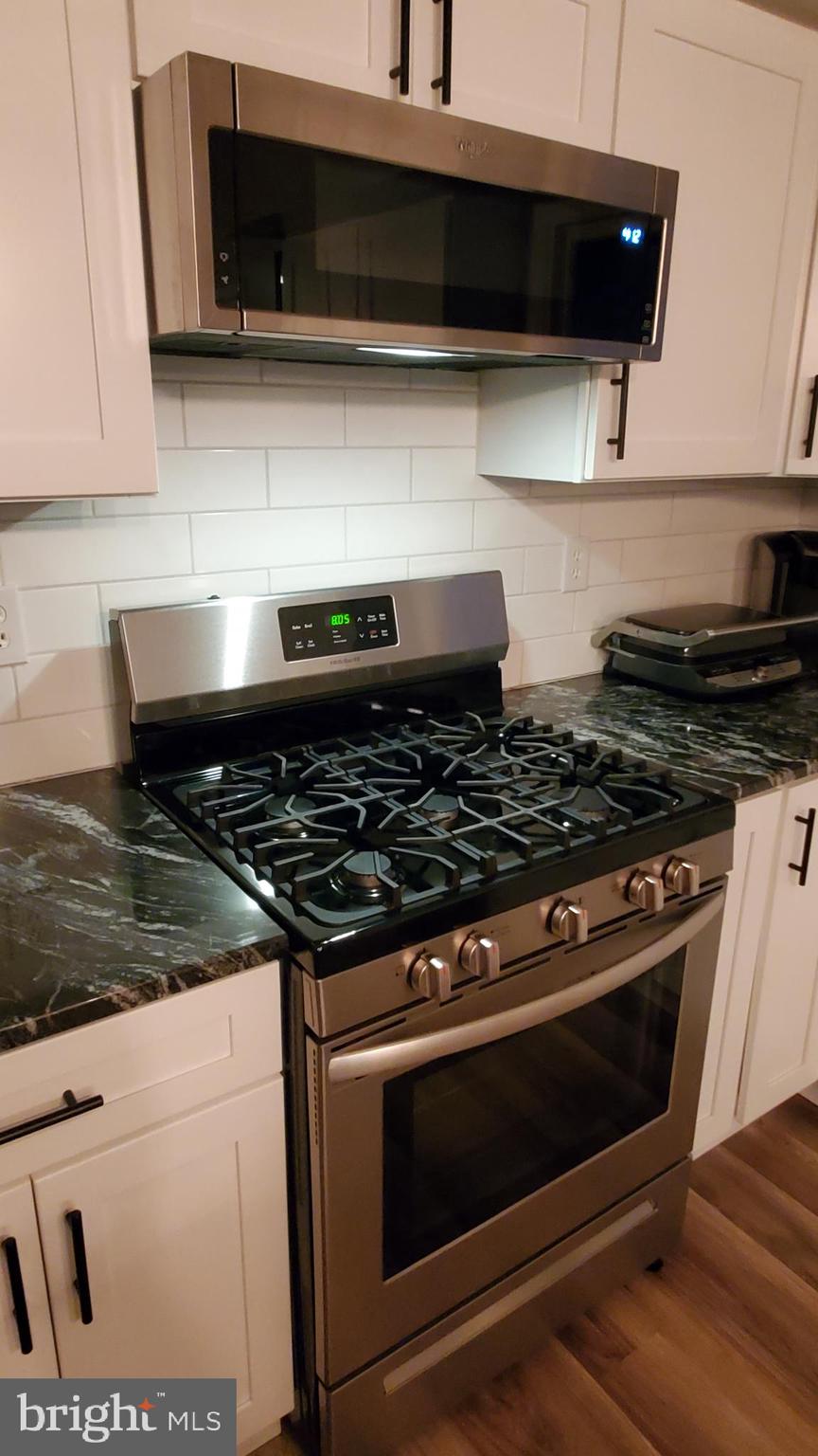 916 Timber Lane Reading, PA 19608 - Photo 9 of 29 a stove top oven sitting inside of a kitchen