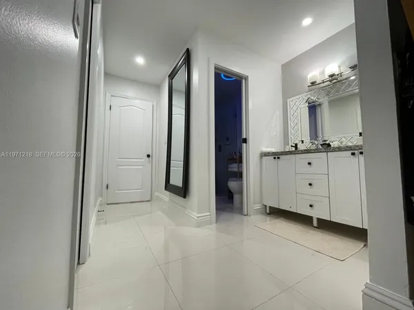 a view of a hallway with chandelier