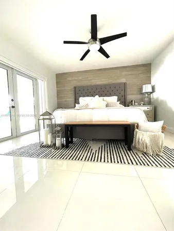 a living room with a balcony furniture and a large window