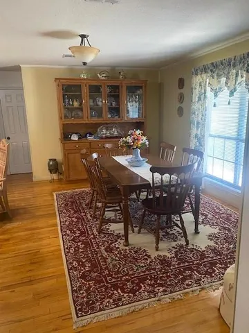 a view of a small house with a yard