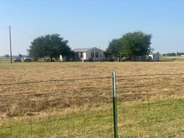 a living room with stainless steel appliances furniture and a wooden floor
