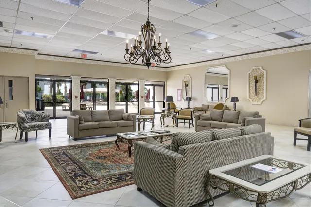 a living room with fireplace furniture and a chandelier