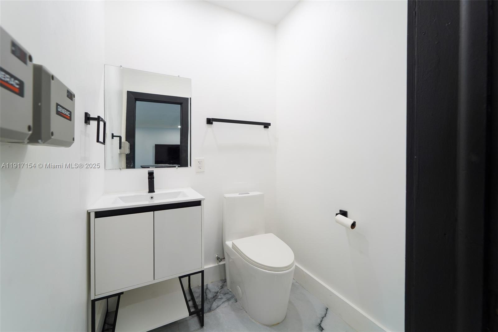 1850 Northeast 199th Street Miami, FL 33179 - Photo 16 of 29 a bathroom with a toilet a sink and mirror