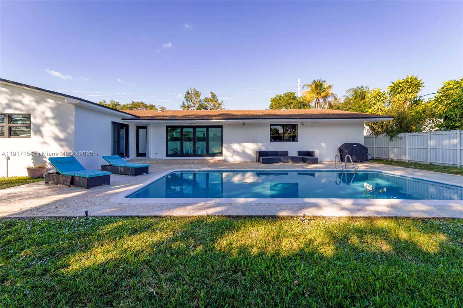 1850 Northeast 199th Street Miami, FL 33179 - Photo 17 of 29 a view of house with yard outdoor seating and swimming pool