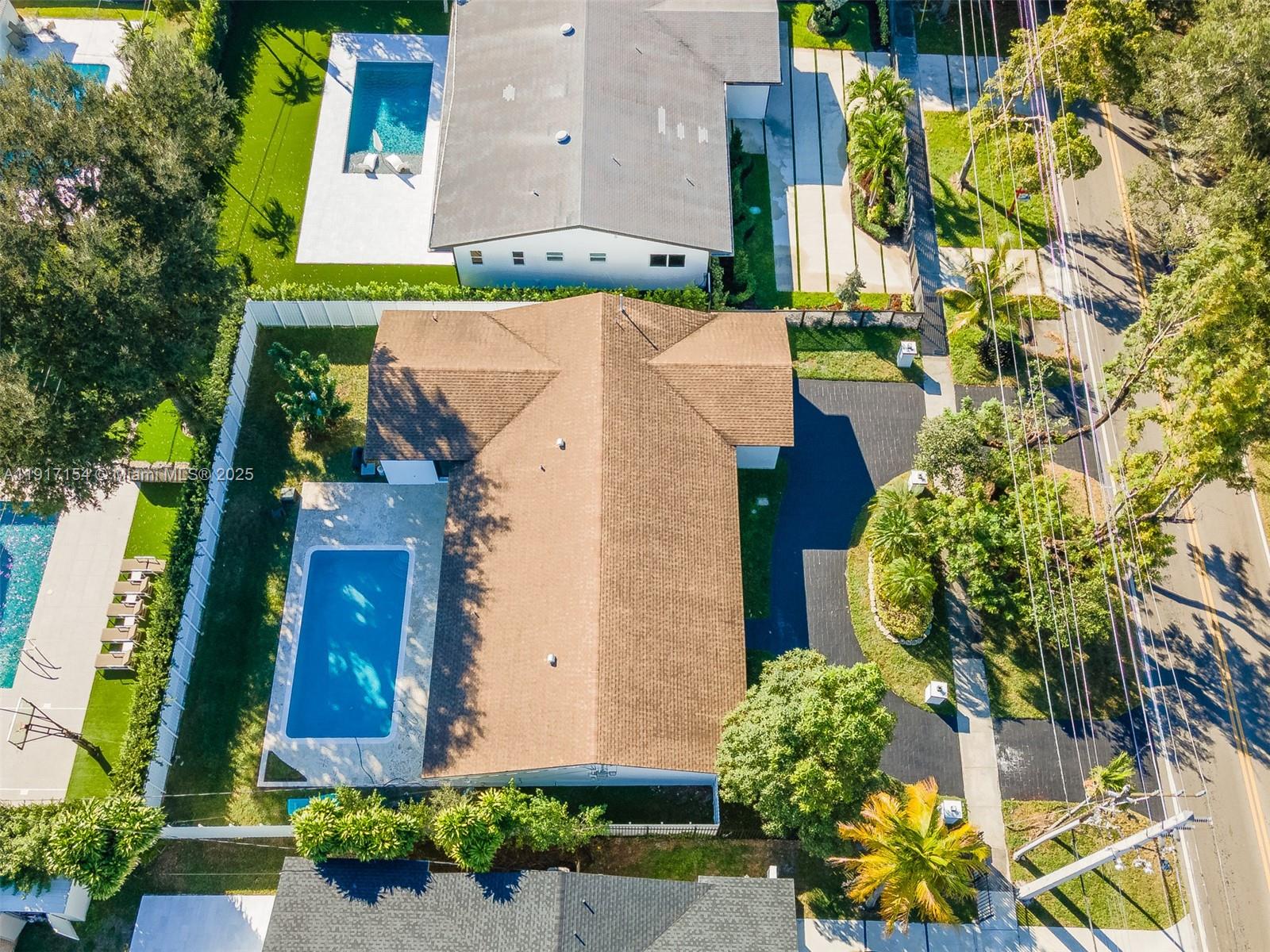 1850 Northeast 199th Street Miami, FL 33179 - Photo 28 of 29 a aerial view of a house with a yard and large trees