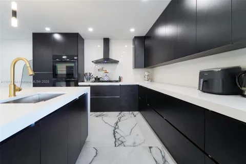 a kitchen with stainless steel appliances a sink dishwasher a stove a refrigerator and cabinets with wooden floor