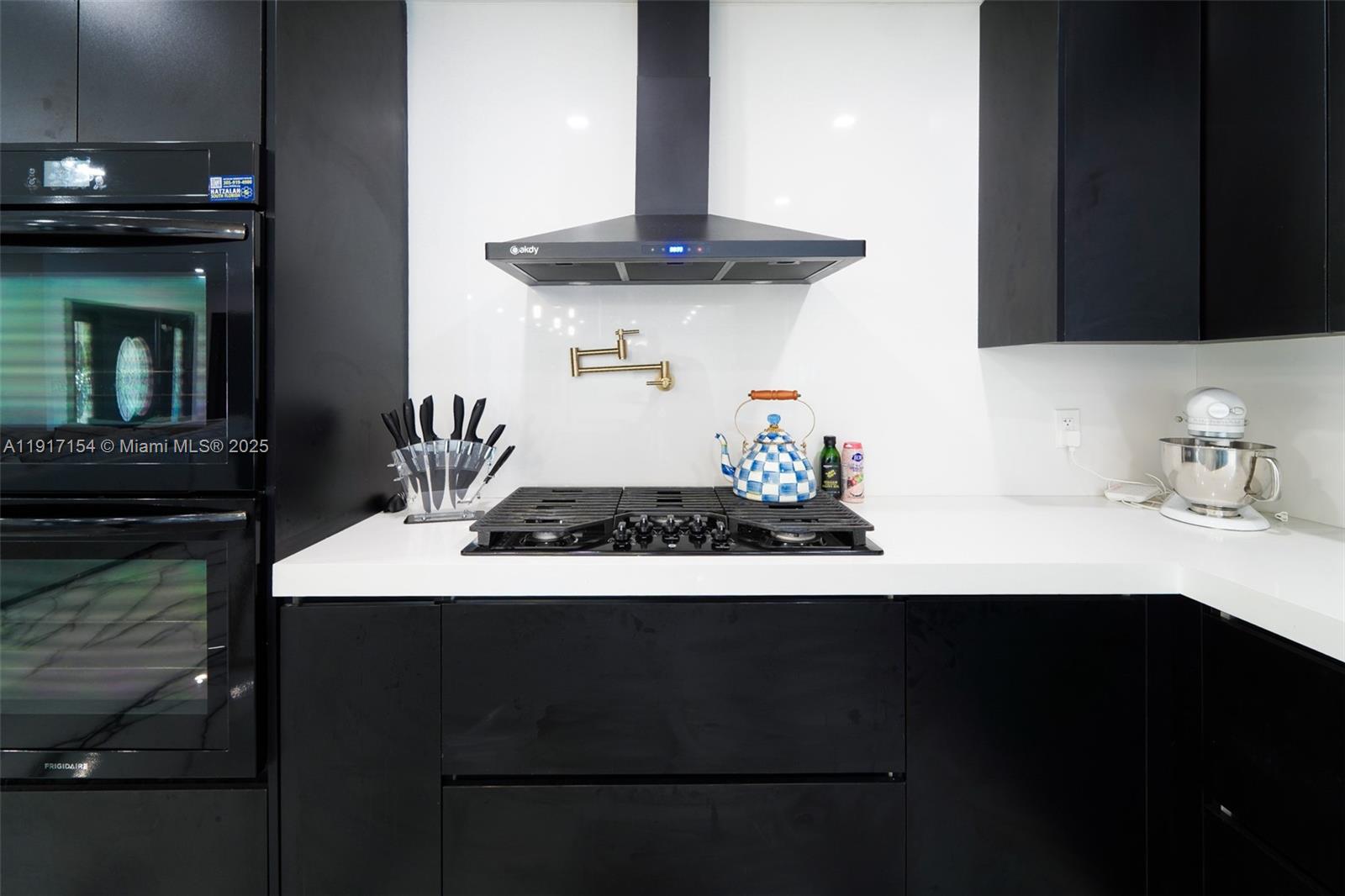 1850 Northeast 199th Street Miami, FL 33179 - Photo 6 of 29 a kitchen with a sink and a stove top oven
