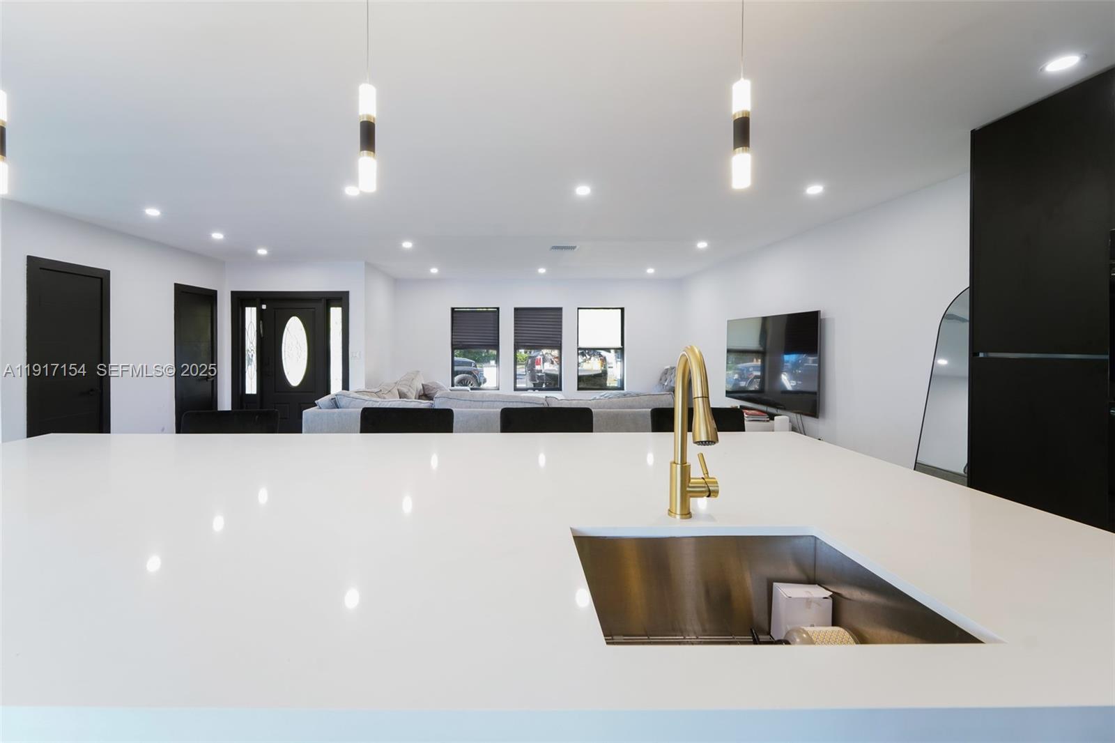 1850 Northeast 199th Street Miami, FL 33179 - Photo 7 of 29 a large kitchen with stainless steel appliances a large counter top a refrigerator and a sink