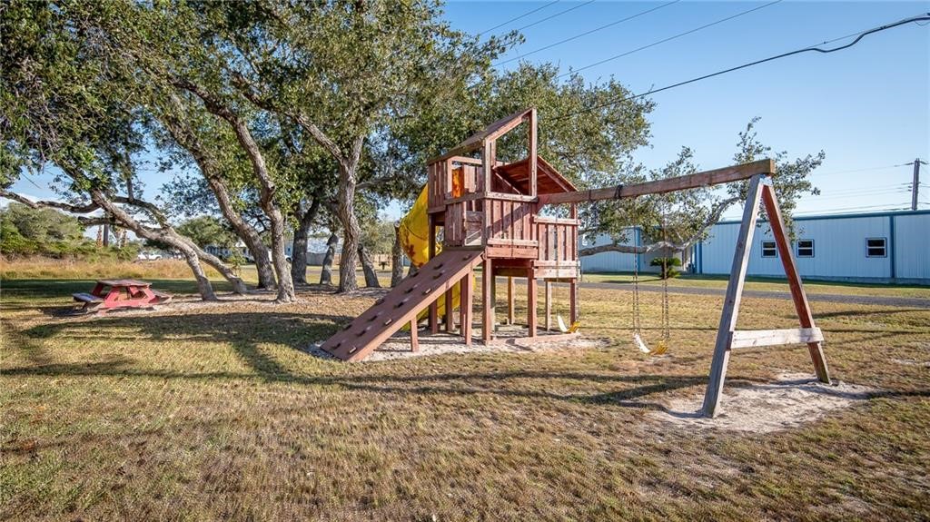 423 Palmetto Point Road Rockport, TX 78382 - Photo 20 of 21 a view of a house with a park