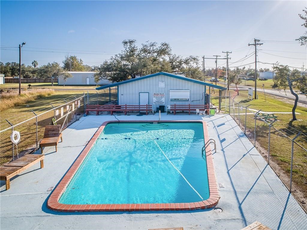 423 Palmetto Point Road Rockport, TX 78382 - Photo 21 of 21 a view of a swimming pool with a lounge chairs