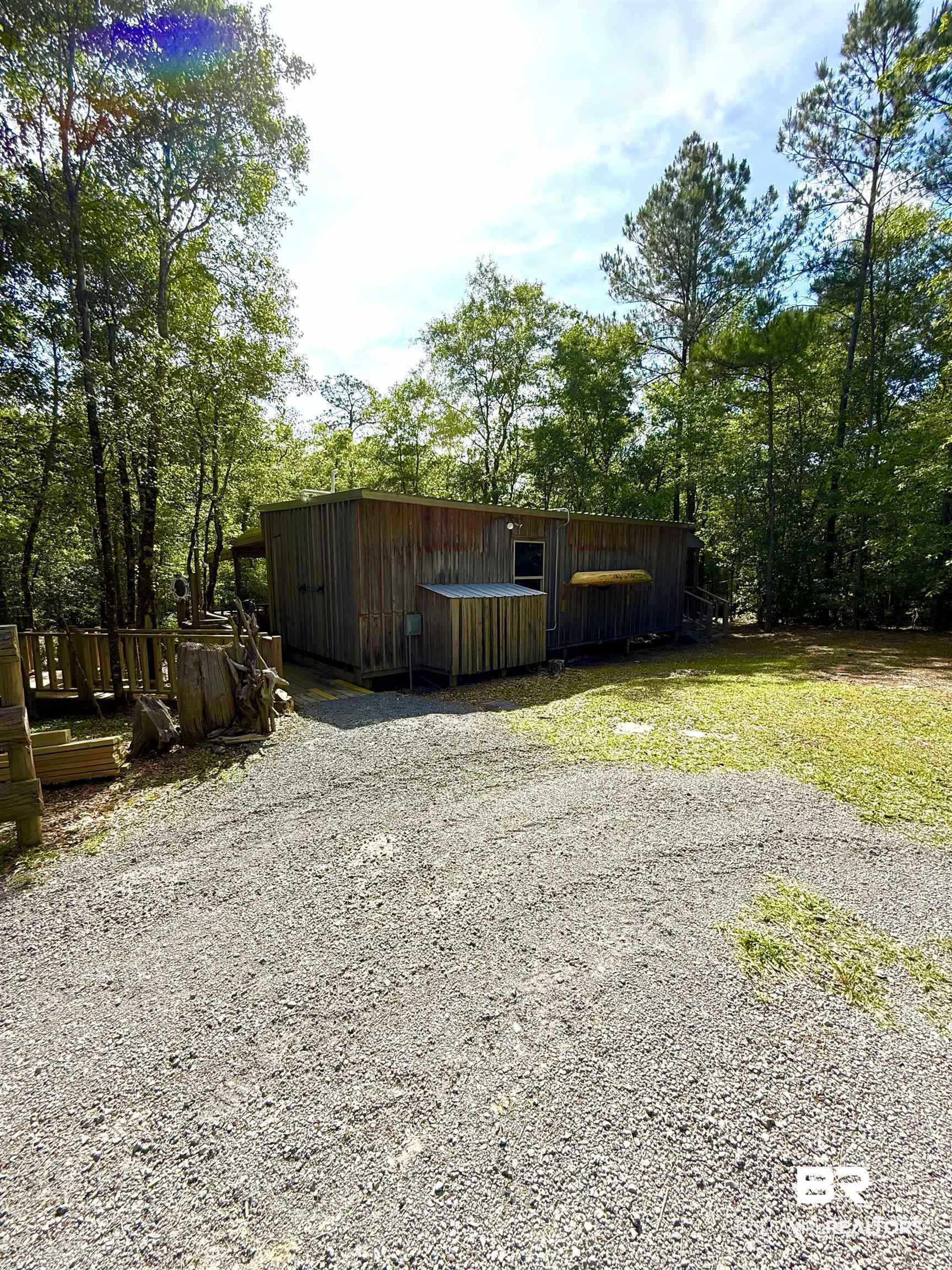 1 Mason Ferry Road Citronelle, AL 36522 - Photo 3 of 40 Wood-sided structure with a gabled roof and a gravel driveway
