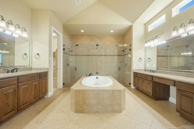a bathroom with a sink a large mirror and a bathtub