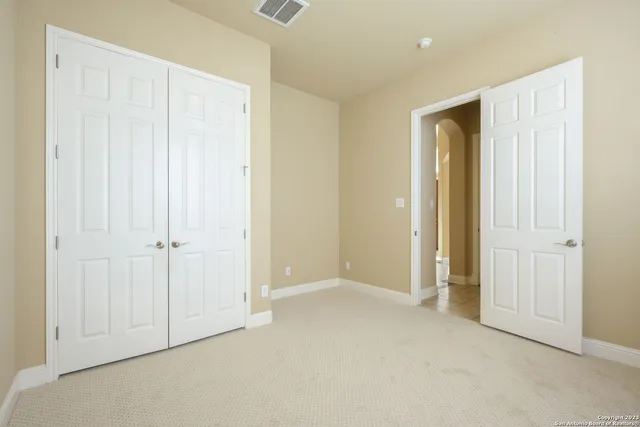 an empty room with closet area