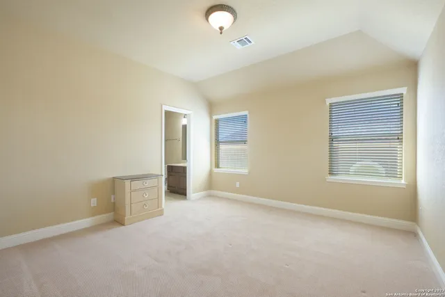 an empty room with windows and closet