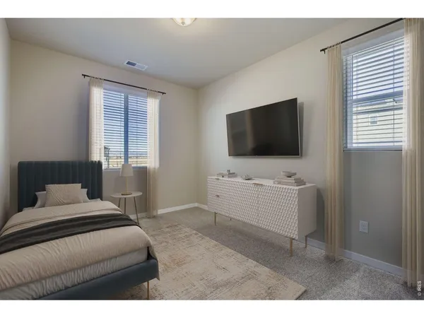 a bedroom with a bed and a night stand